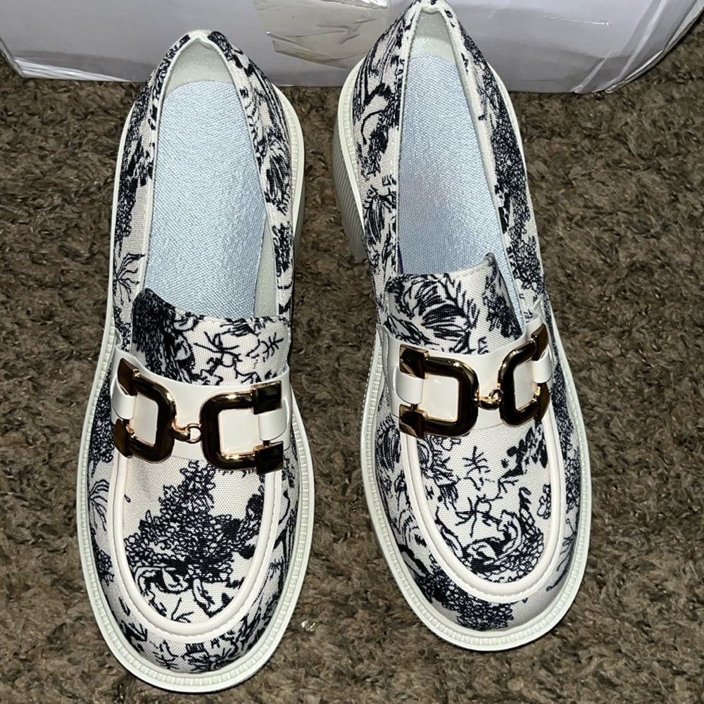 Black and cream colored Mary Jane loafers